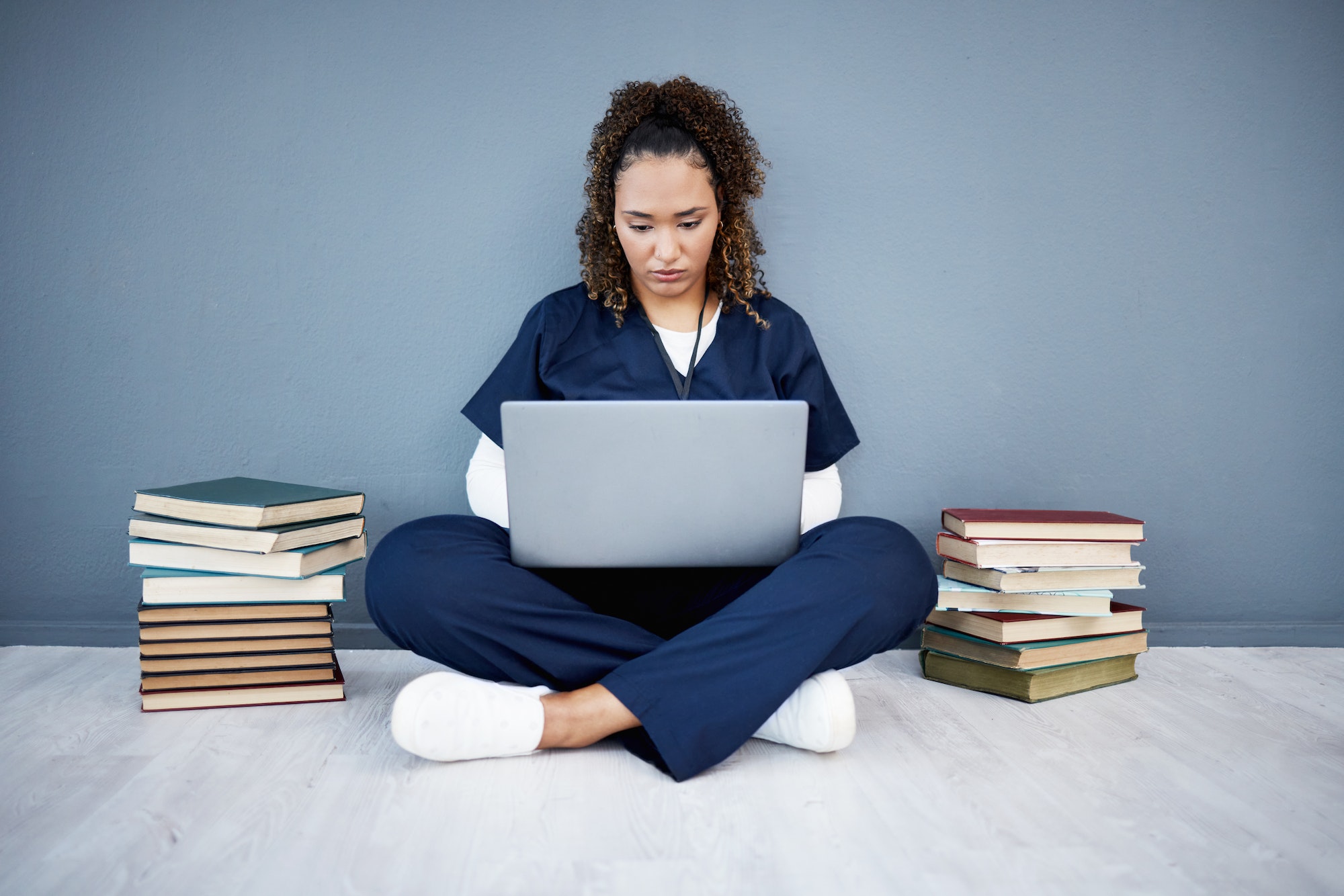 Nurse, laptop or typing in hospital research, wellness books study or education in medicine scholar